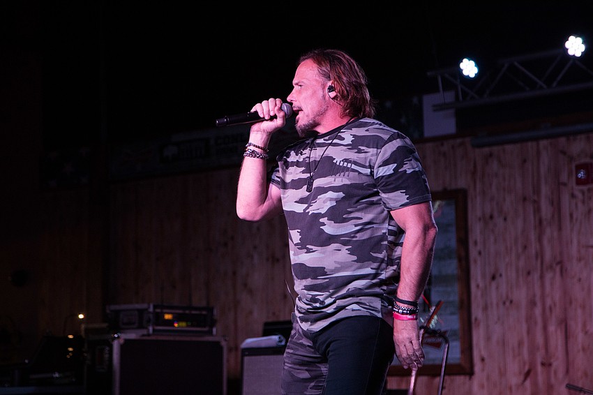 Billy McKnight from Soul Circus Cowboys sings on stage.