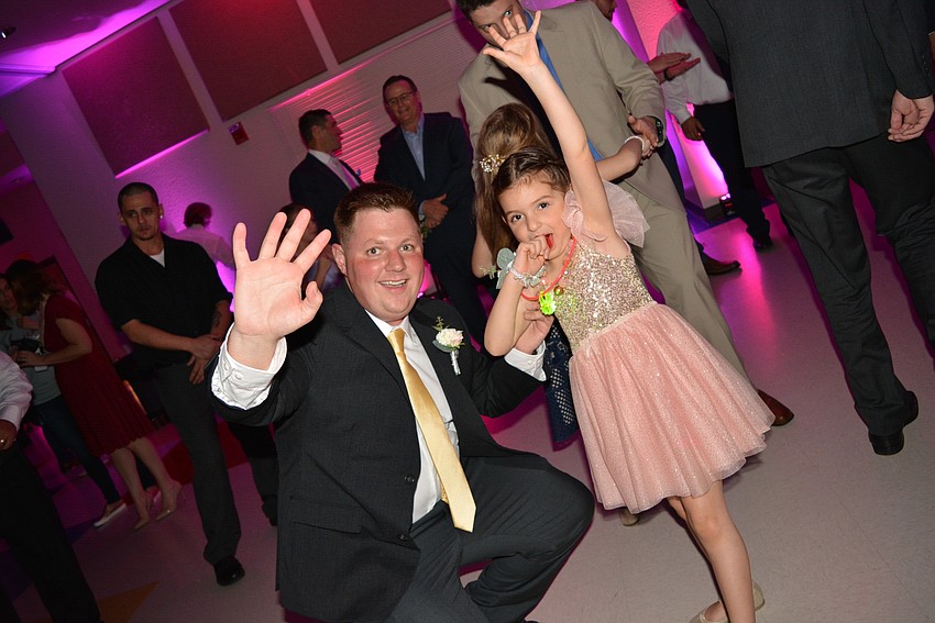 David Brecka dances with his 5-year-old daughter Sarah, who feasts on a Ring Pop while she dances.