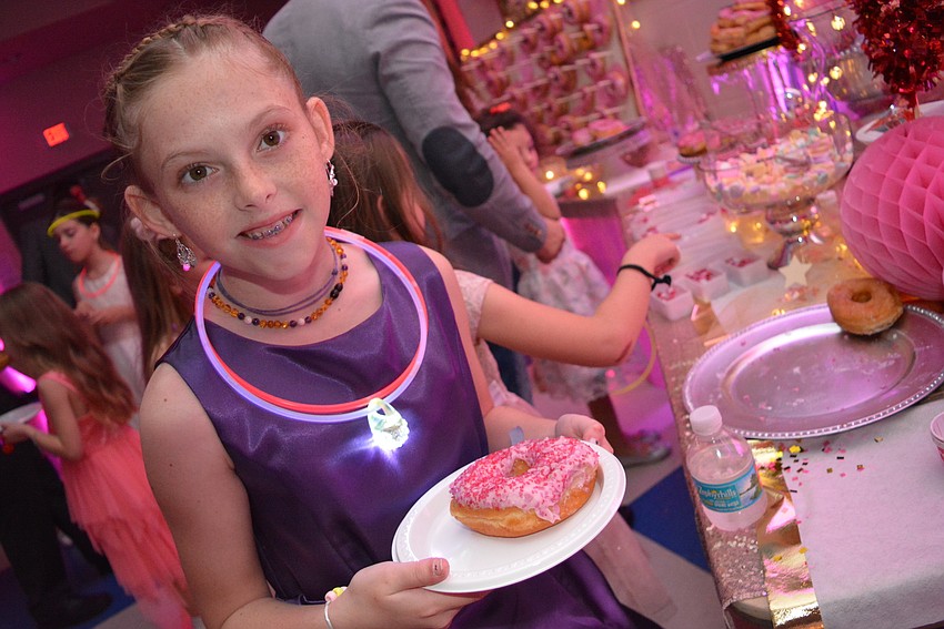 Ten-year-old Oceana Yarish finds the perfect doughnut at the snack station.