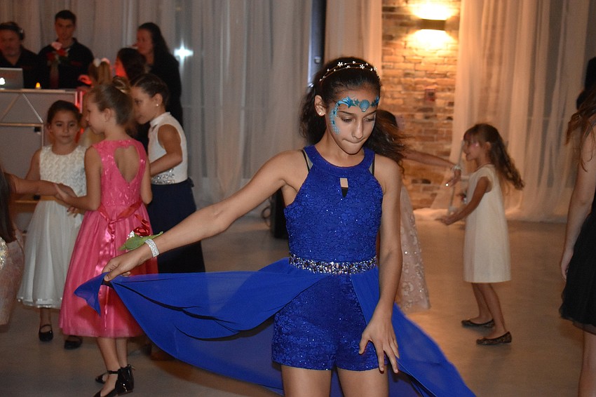 Angela Santiago dances to the music.