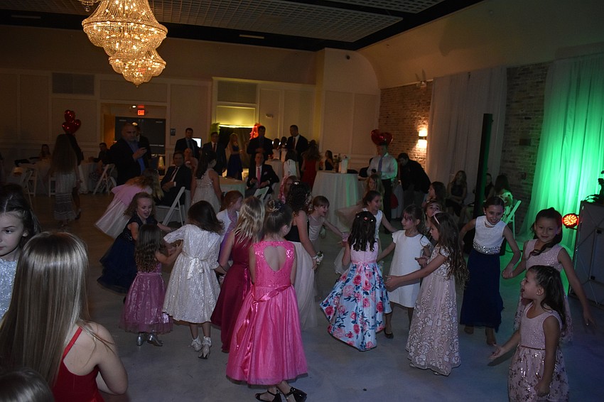 The girls joined hands to dance all over the floor.