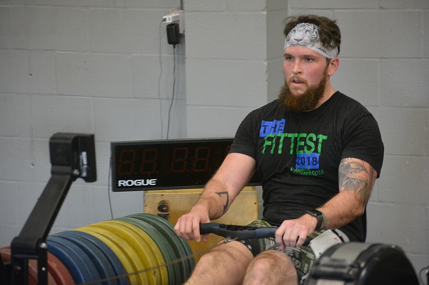Travis English competed in the Dry Tri portion of the event where the rowing was done on machines inside CrossFit Lena.