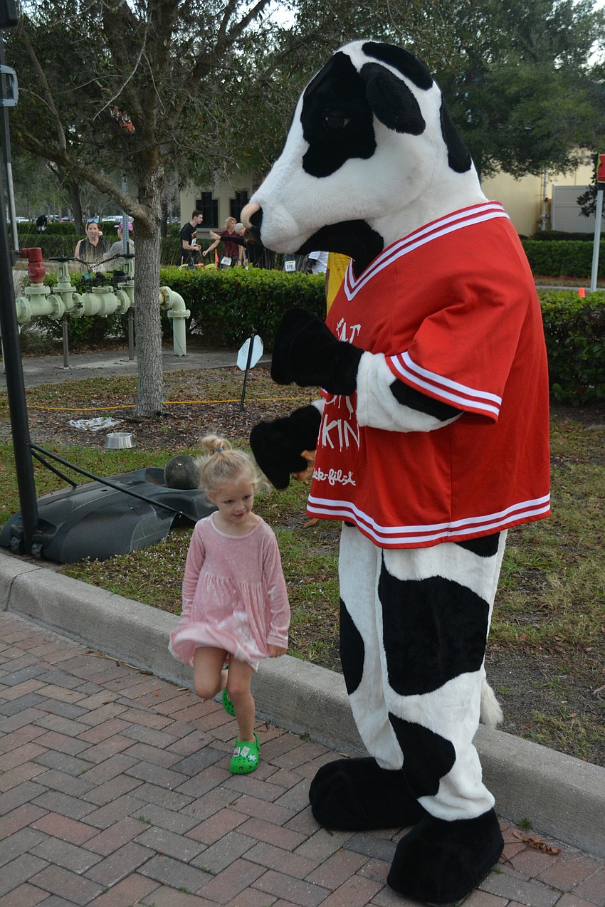 Palmetto 3-year-old Savannah Cosens didn't run, but she got to dance with the Chick-fil-A mascot.