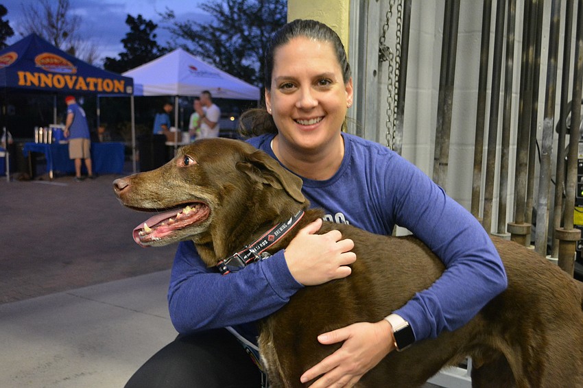Palmetto's Sarah Calandra and Maddox, a chocolate lab, get ready to run in the runners/dogs.