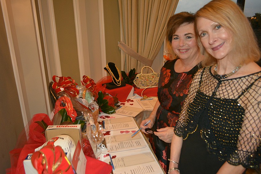 Lakewood Ranch's Barbara Matazinski and Sarasota's Linda Morgan check out the silent auction items.