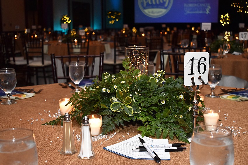 Green centerpieces twinkled when the lights dimmed.