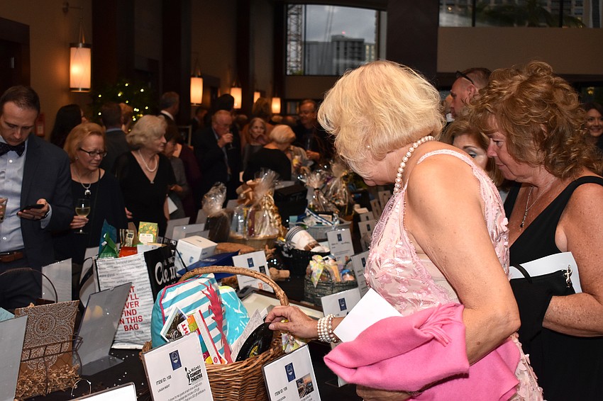 Denise Ryan checks out the extensive silent auction item selection.