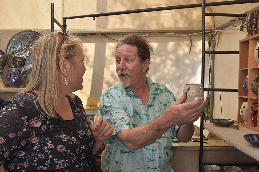 Jenny Carlson learns about a piece of pottery made by John Coburn.