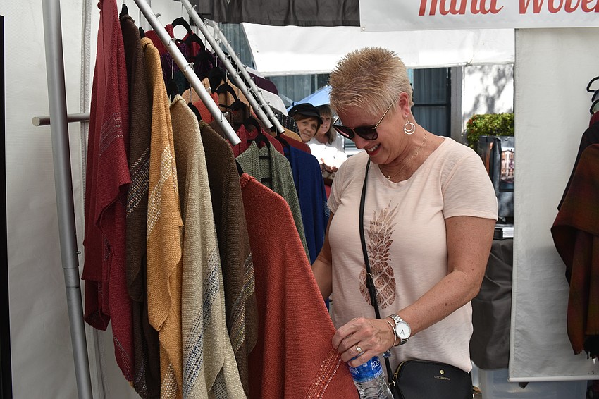 Patty Bandeen looks through the clothes for sale.