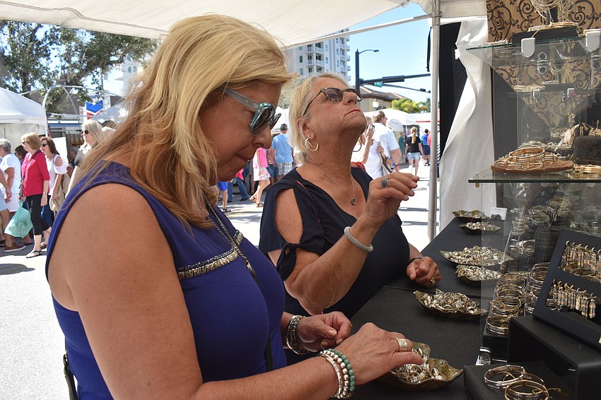 Zoe Anderzack and Mary Jo Griewahn look through the jewelry.