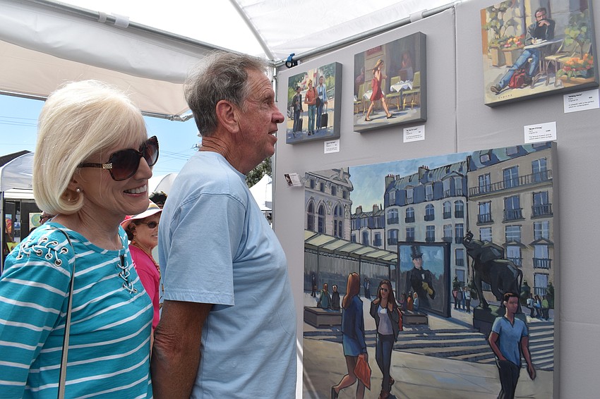 Shirley and Bill Peach take a look at art by Linda Hugues.