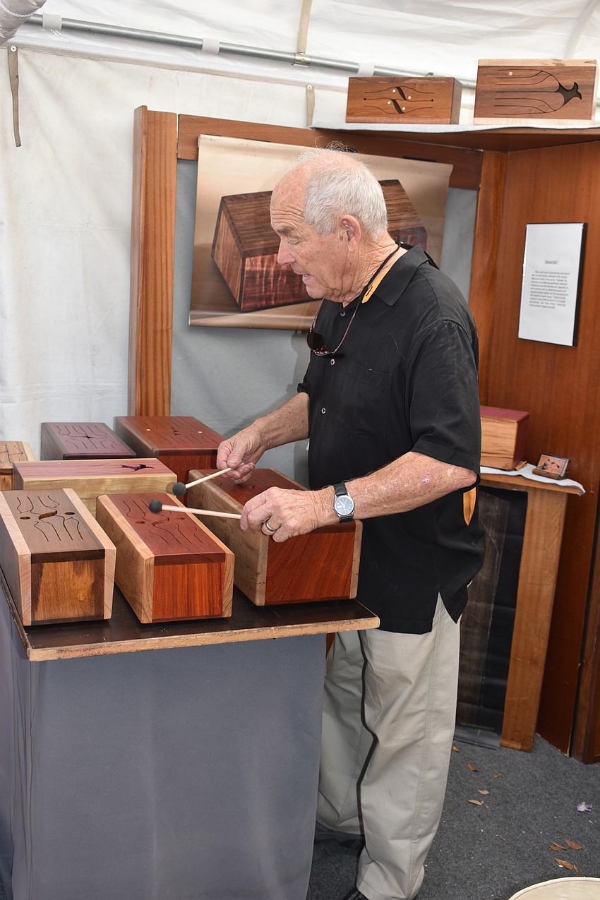 Michael Thiele plays on a a wooden box for lookers on.