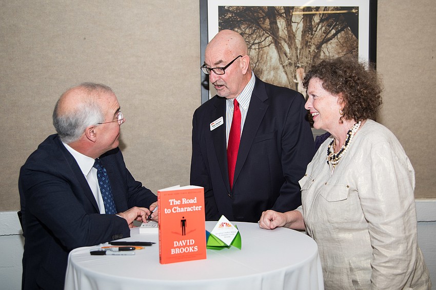 Peter and Mary Ann Pearson get their book signed by David Brooks.