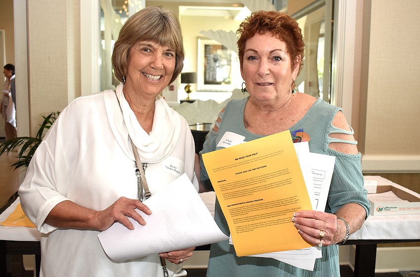 Becky Vander Bogert and Arlene Skervsky asked attendees to sign petitions to expand Medicaid and ban semiautomatic assault weapons.
