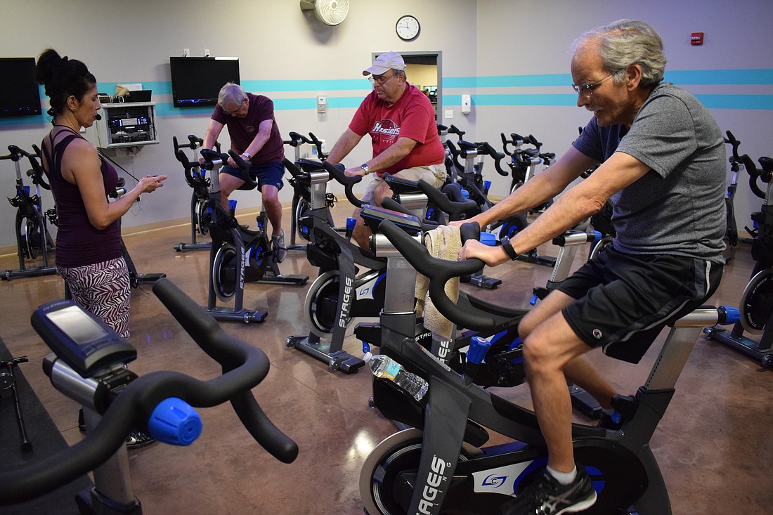 Hope Hahn leads bikers Ron Whittle, Larry Ivers and Tom Schneberger in their exercise class.