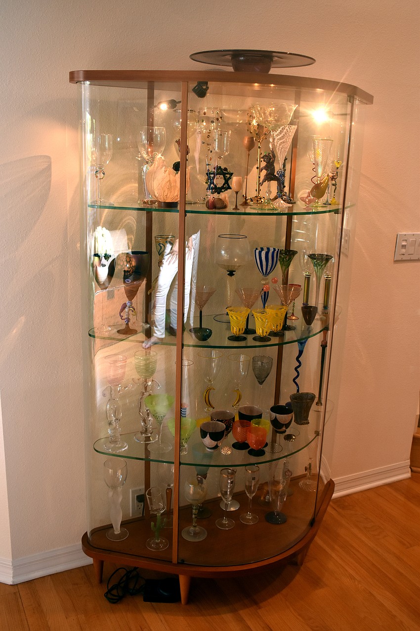 A glass collection sits off the foyer of the entrance.