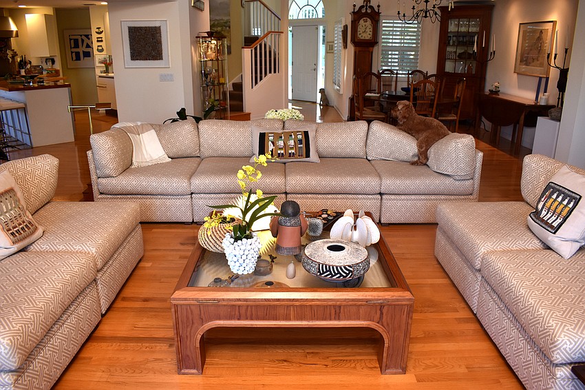 The living room offers plenty of seating with three couches.