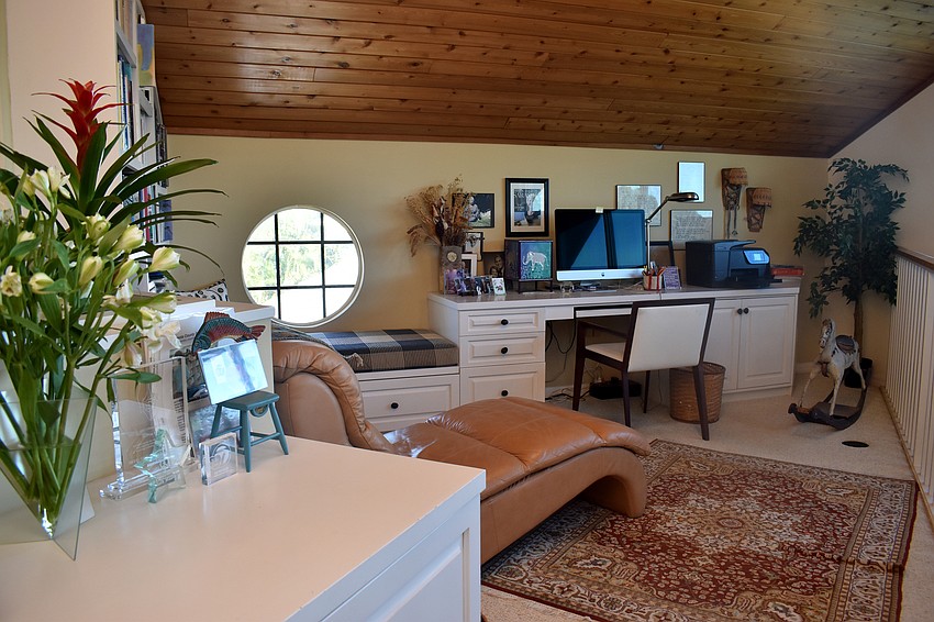 Upstairs, Ruth Maass has turned a loft area into a work space.