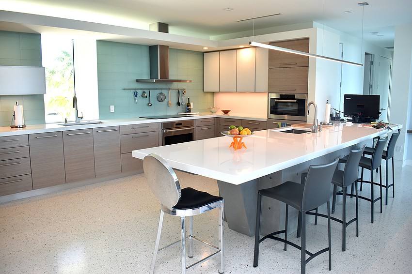 The kitchen features seating at a countertop.