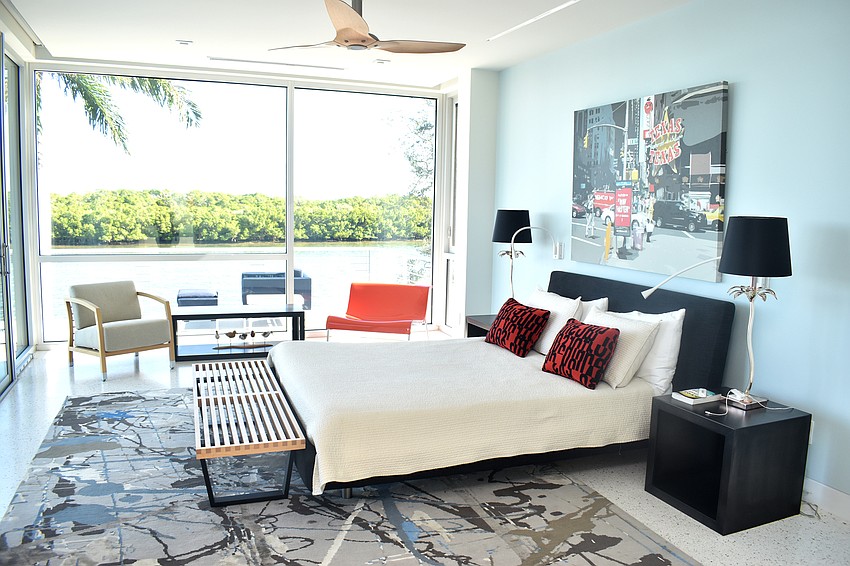 The master bedroom features large windows that offer a view of Harris Bayou.