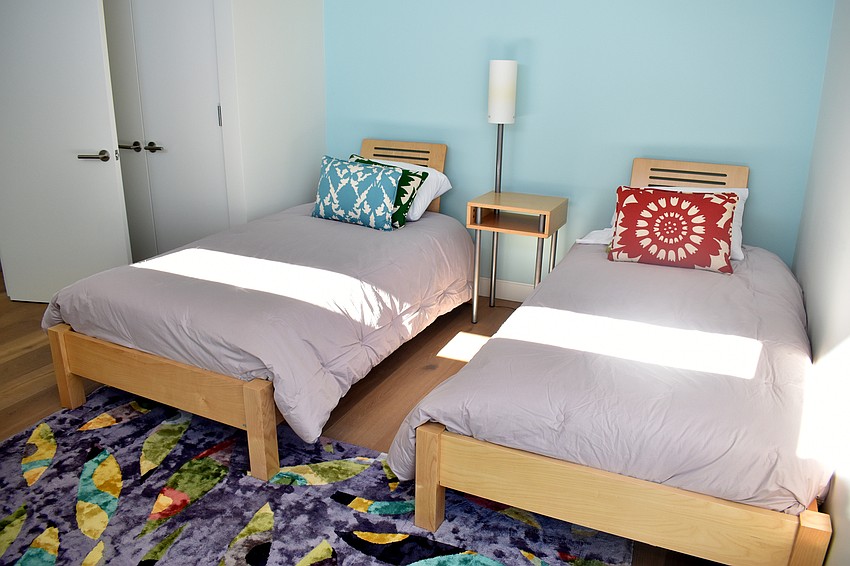A guest bedroom has two twin beds for visitors to use.