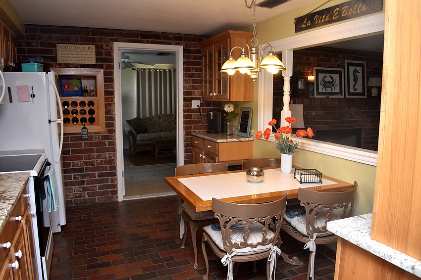 The kitchen is off the living room and leads to a guest suite.