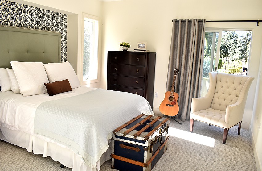 A guest bedroom with plenty of natural light overlooks the front yard.