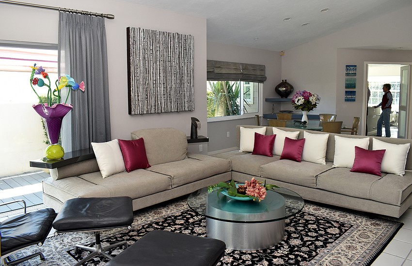 The living room area has a tan, black and dark pink color scheme.