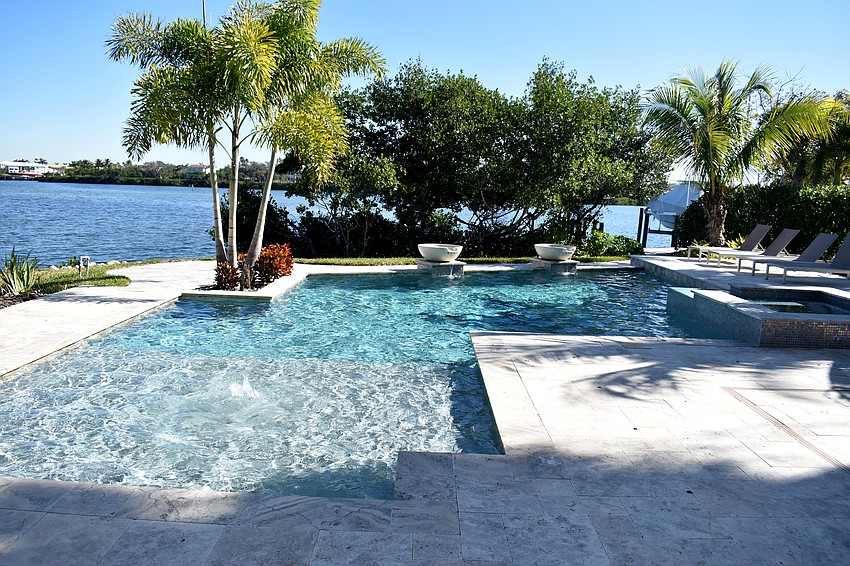 In the back of the house, a resort-style pool overlooks Sarasota Bay.
