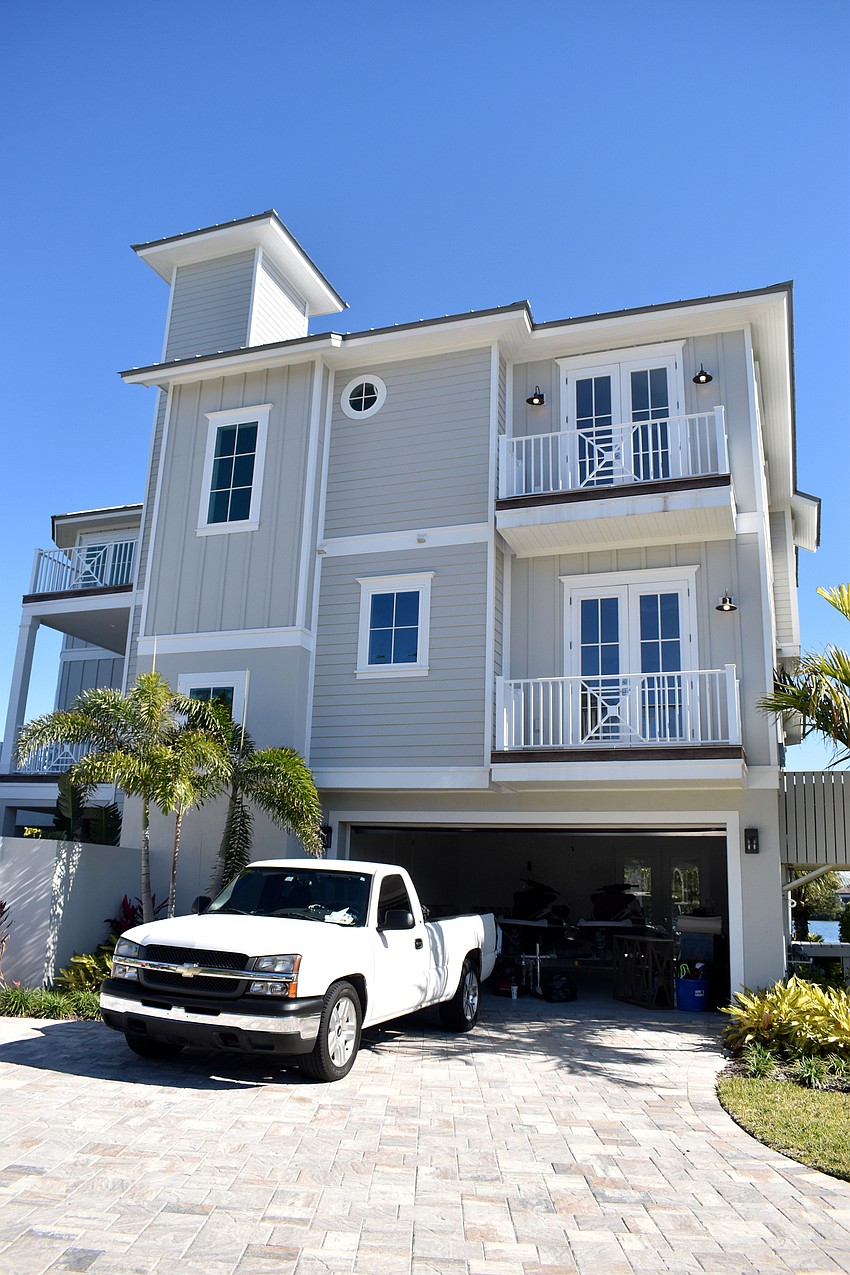 The home is on the bay side of Gulf of Mexico Drive, but a rooftop deck offers views of both Sarasota Bay and the Gulf of Mexico.