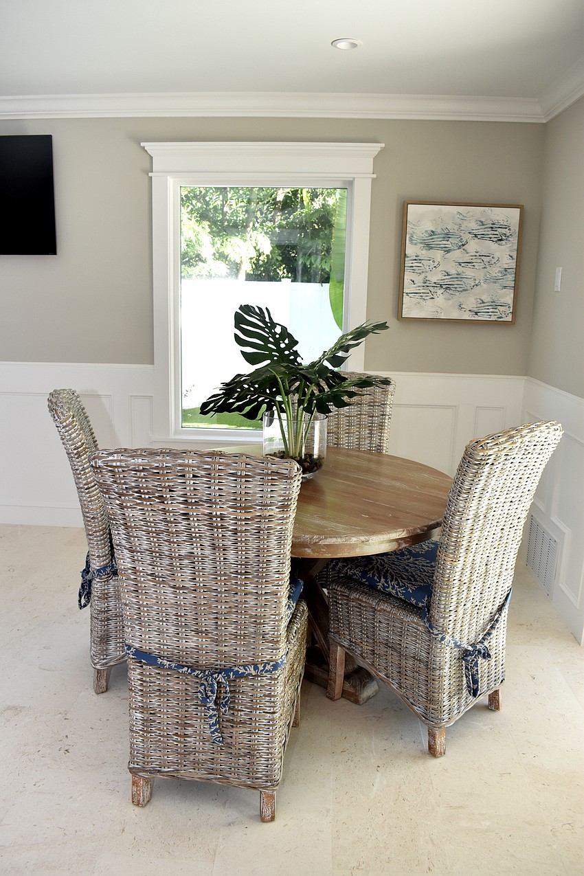 A living room area is on the bottom floor that walks out to the pool deck.