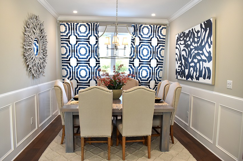 The dining room has cream walls with blue decor.