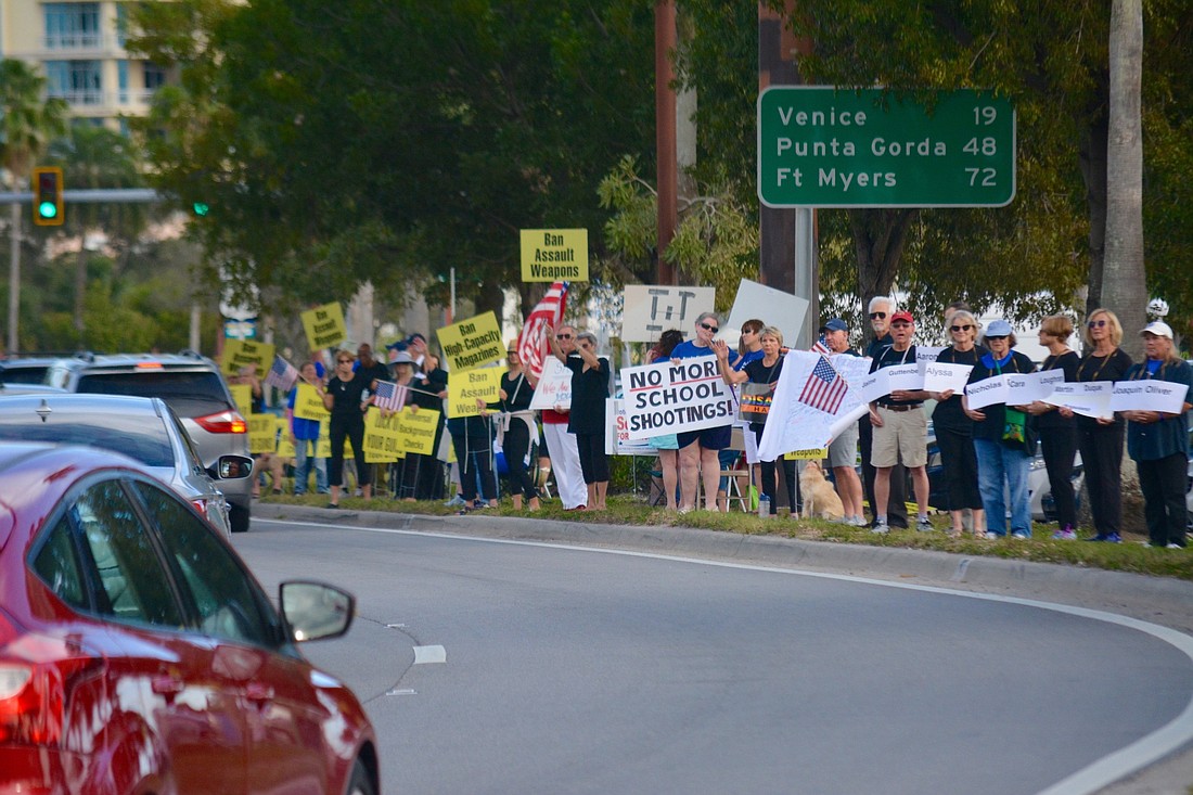 Attendees lined the street on the bayfront and held all types of signs and flags.
