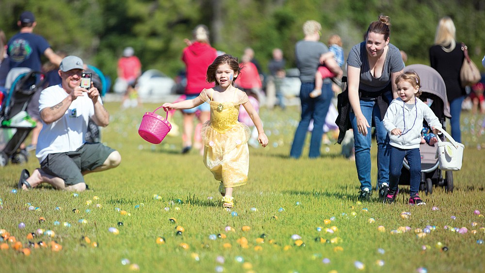 Four-year-old Madison Straw rushes for eggs at the 2018 EGGstravaganza.