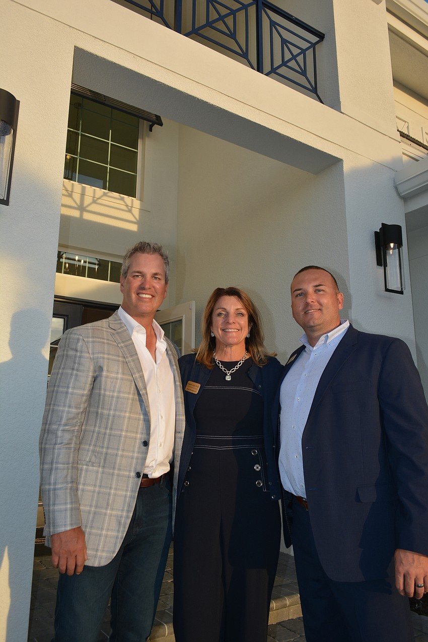 Owner and CEO Brian Stock and vice presidents Claudine Leger-Wetzel and Van Osborne are excited about the grand opening of eight new Stock models at Genoa at the Lake Club.
