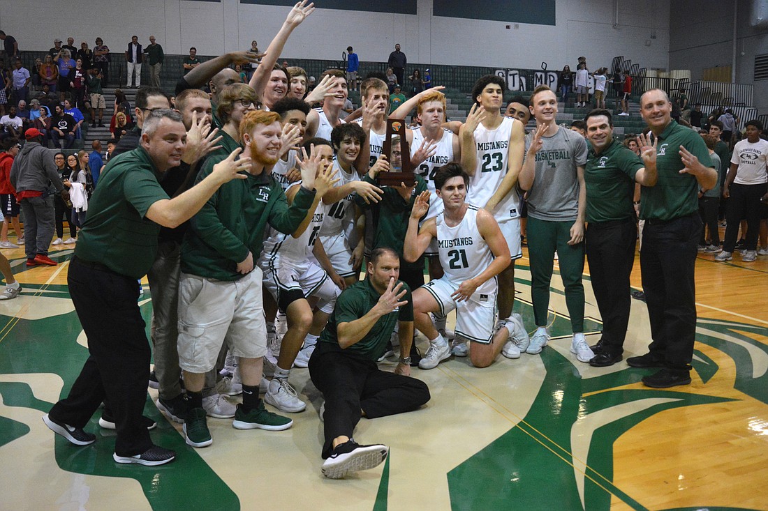 The Mustangs celebrate their fourth-straight district title.