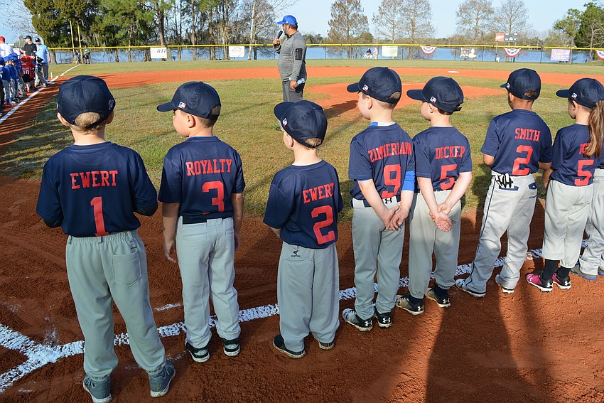 Players line the field for the national anthem and the season's first pitch.