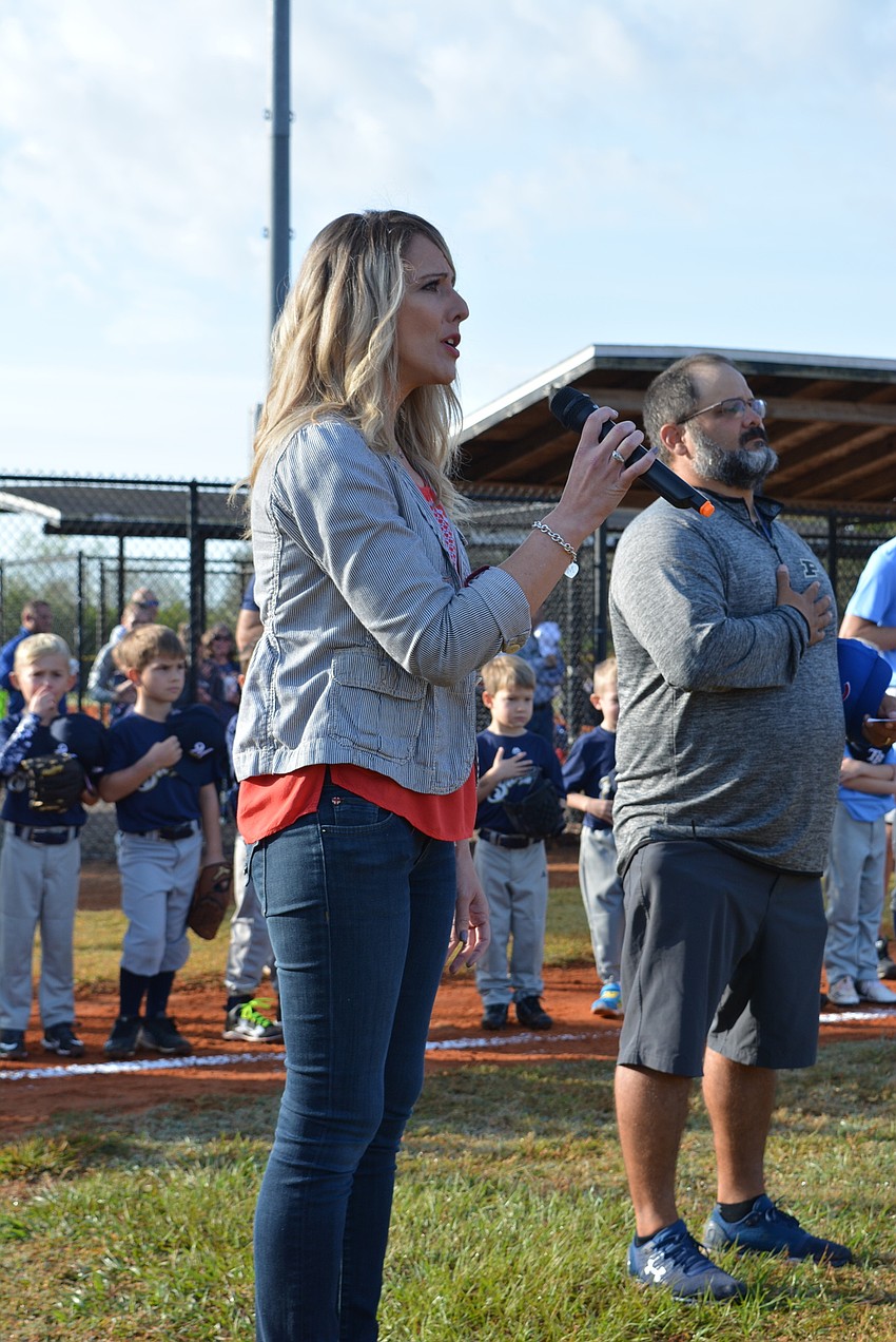 Christina Soderberg, aunt of player Andrew Fertig, sings the national anthem as part of opening ceremonies.