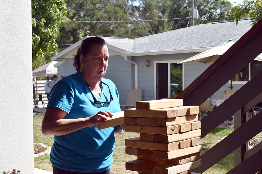Celia Moore sighs a breath of relief after she successfully dislodges a block from the Giant Jenga tower.