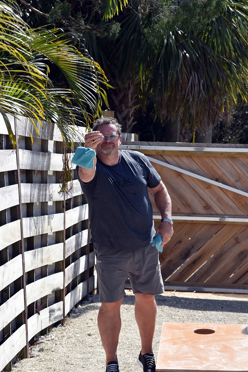 Barry Rookes tries to bring his team to victory during a game of corn hole.
