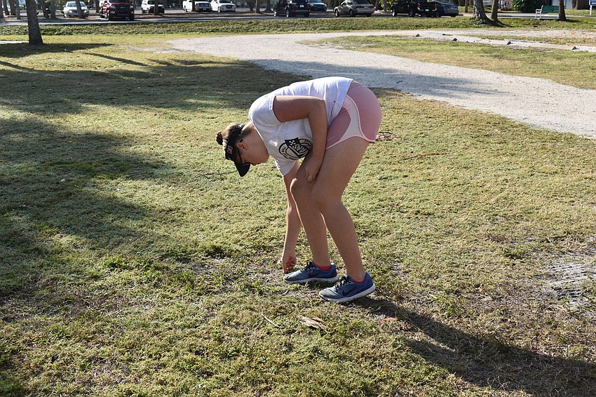 Hannah Mauer picks up some litter.
