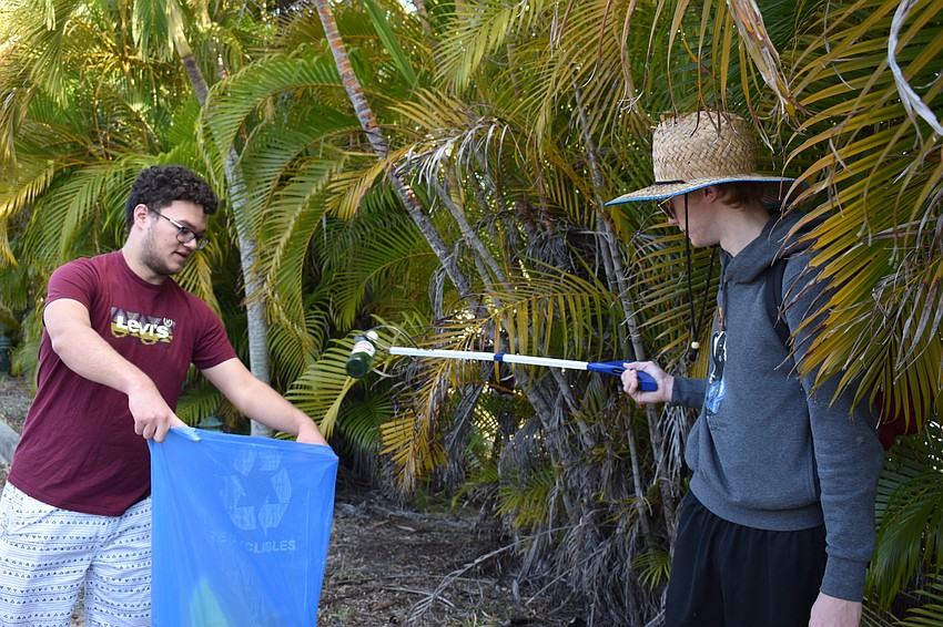 Gabriel Correa and Joshua Moore teamed up to pick up the trash more efficiently.