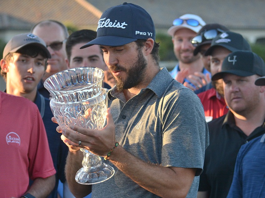 Mark Hubbard stares into his LECOM Suncoast Classic trophy.
