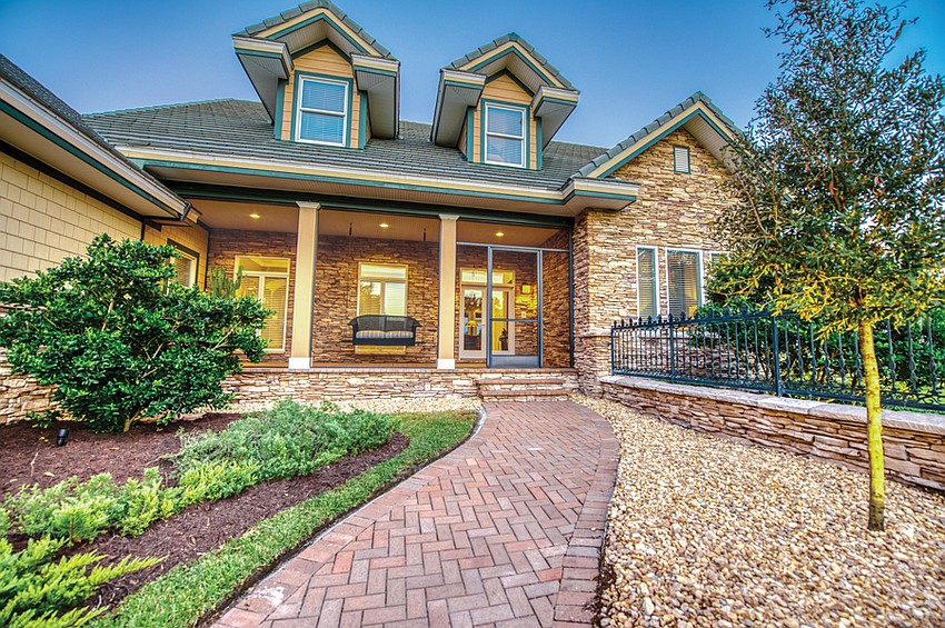 The home offers traditional styling, with five bedrooms and a three-car garage. The front porch is screened and features an old-fashioned swing.