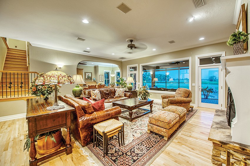 Comfortable seating in the family room invites guests to linger and enjoy the view out over the pool to the track where the horses are trained.