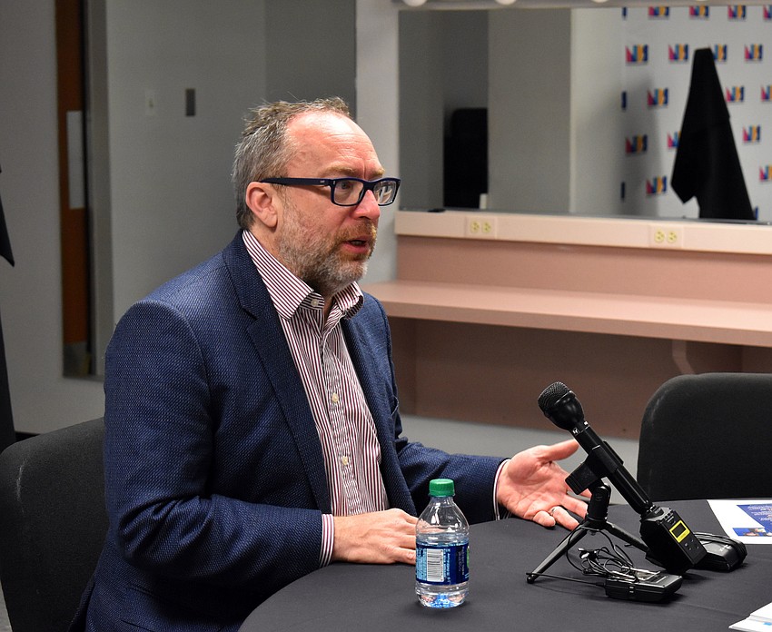 Jimmy Wales fields questions from reporters before giving his lecture.
