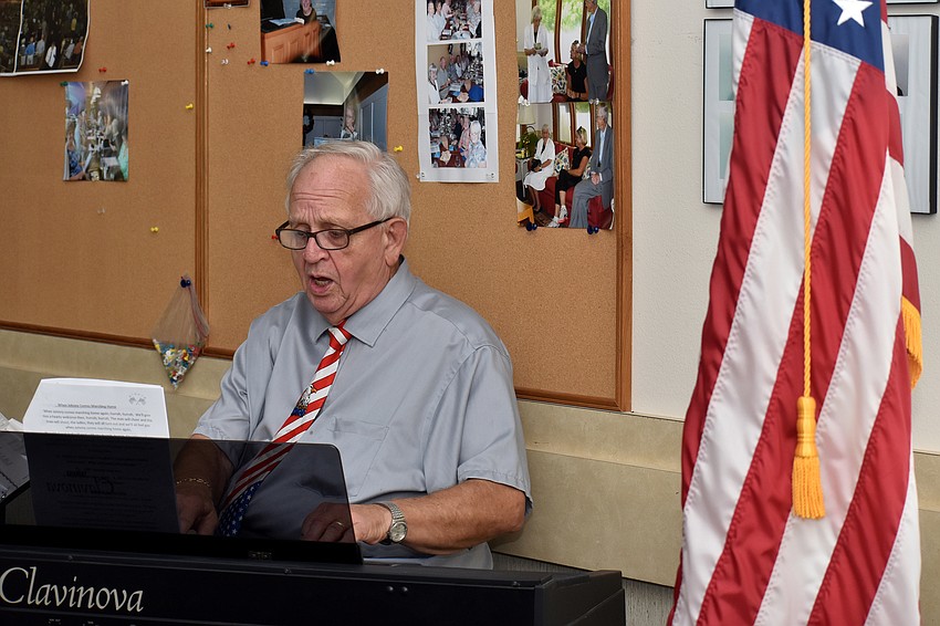 Dale Hooey leads the singalong while playing piano.