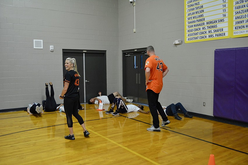 Mike Wright Jr. and Madison Wright cheer students on through their leg lifts and crunches.