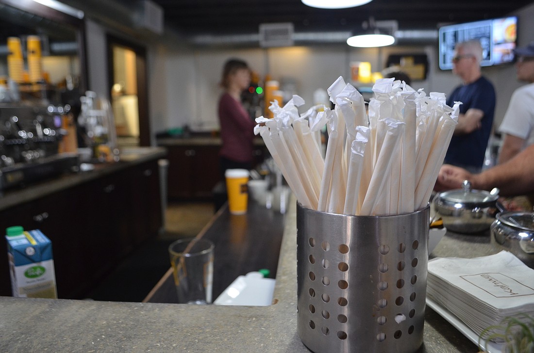 Businesses such as Kawha Coffee have voluntarily switched to paper straws, but city officials are concerned about the costs associated with more stringent regulations.