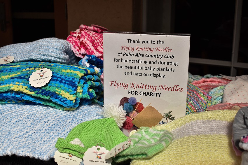Work by a Palm Aire Country Club group, Flying Knitting Needles, was on display so guests could see the handcrafted baby blankets and hats members made for clients.